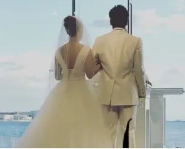 梅野隆太郎さん夫妻とされるが人物を確認できない新郎新婦の後ろ姿